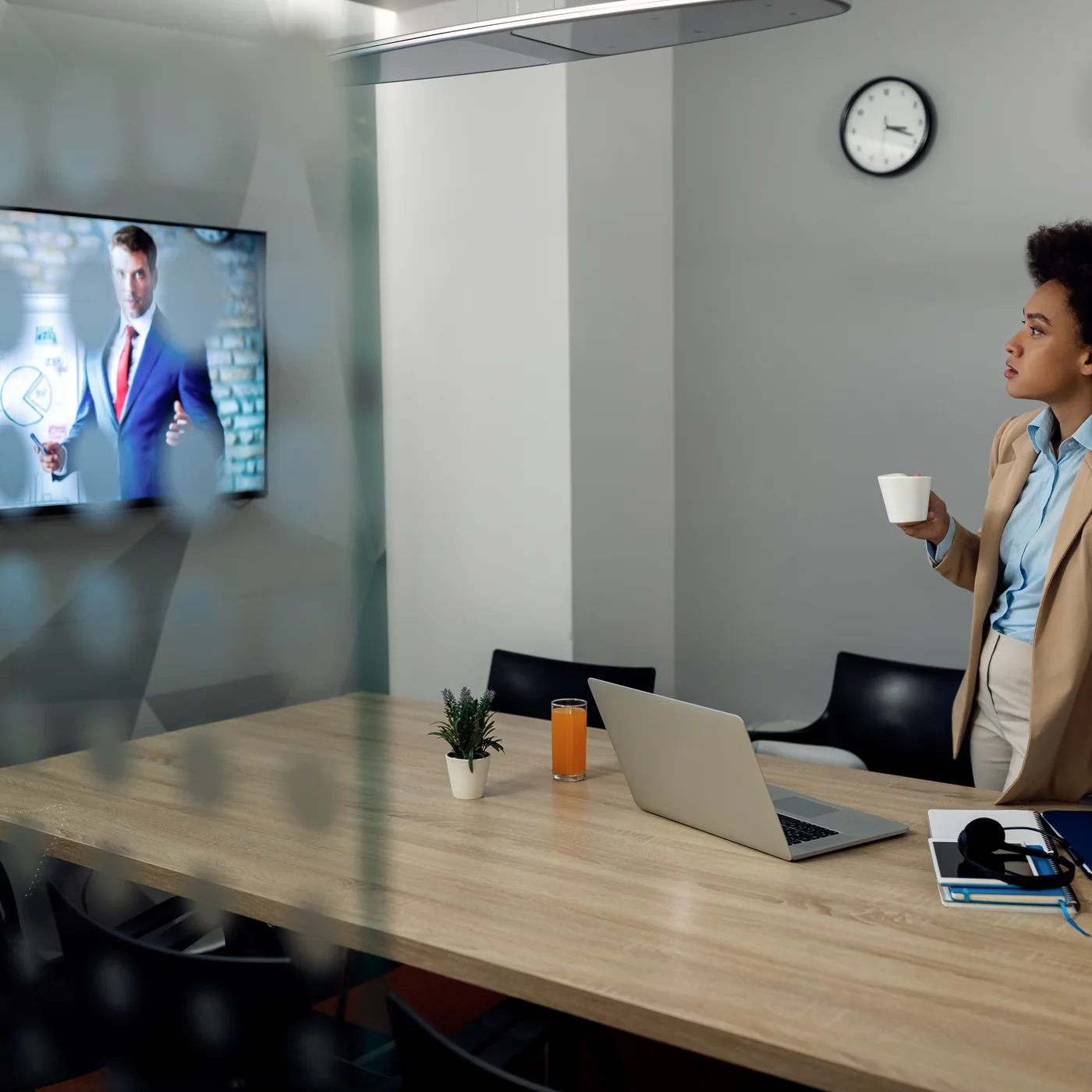 Black businesswoman using conference room video call equipment