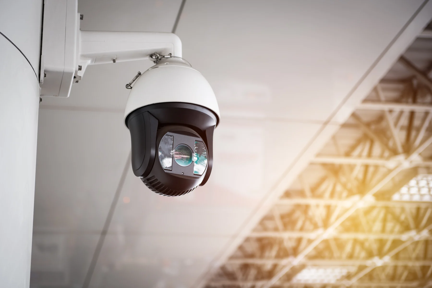 CCTV camera hanging from a commercial roof for surveillance coverage