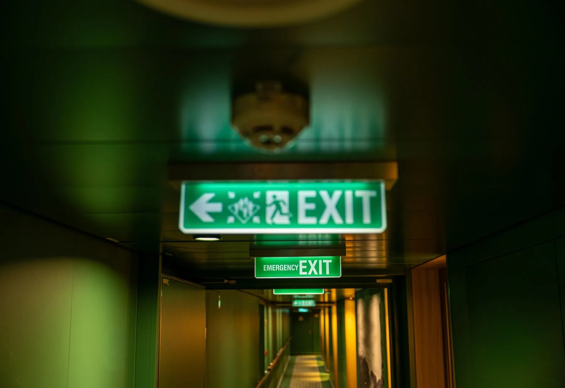Illuminated emergency exit signs and alarm beacon in a commercial building