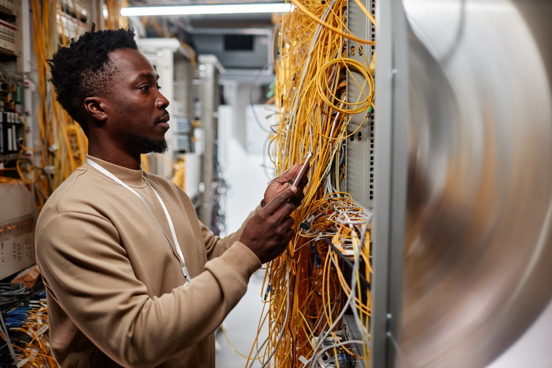 System administrator setting up server infrastructure using a smartphone